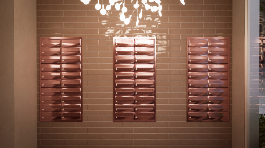 Residential and commercial Mailboxes in rose gold, in the lobby of a building